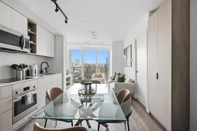 a kitchen and dining room with a glass table and chairs at Elegant 2BR Condo with 55 TV & City Views in Toronto