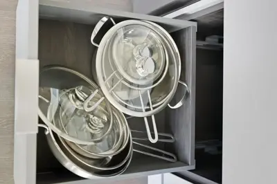 two silver dishes in a drawer in a cabinet at Modern 3BR Condo Sleeps 8 with Floor-to-Ceiling Views in Toronto