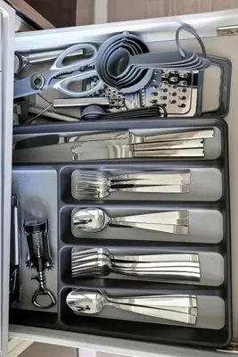 a drawer filled with silver utensils in a refrigerator at Chic Downtown TO Studio Near Entertainment Dist in Toronto