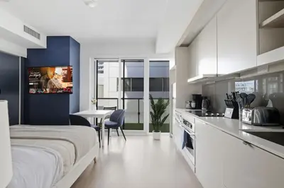 a kitchen and a bedroom with a bed and a table at Chic Downtown TO Studio Near Entertainment Dist in Toronto