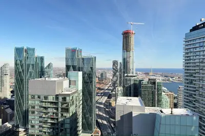 an aerial view of a city with tall buildings at 60th Floor Luxury SkySuite 3BD Lake & City Views in Toronto