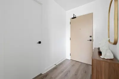 a room with a door and a statue on a table at Modern West Getaway 2BR Condo with Free Parking in Toronto