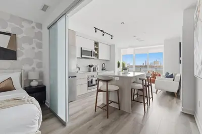 a bedroom and kitchen with a table and chairs at Modern West Getaway 2BR Condo with Free Parking in Toronto