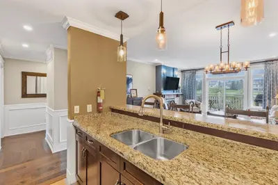 a kitchen with a sink and a living room at The Sweet Spot - Walk to Village & Hot Tub in Blue Mountains