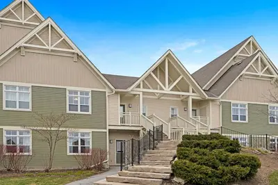 a large house with stairs in front of it at The Sweet Spot - Walk to Village & Hot Tub in Blue Mountains