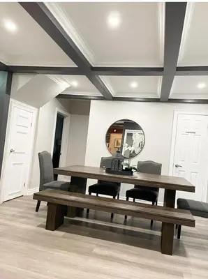 a dining room table with chairs and a mirror at Cottage getaway in the city, for intimate family gathering in Ajax