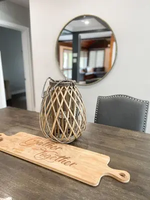 a wooden spoon and a basket on a table with a mirror at Cottage getaway in the city, for intimate family gathering in Ajax