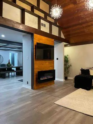 a living room with a fireplace and a couch at Cottage getaway in the city, for intimate family gathering in Ajax