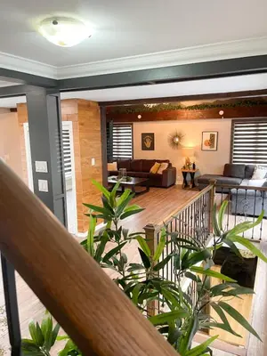 a living room with a couch and a table at Cottage getaway in the city, for intimate family gathering in Ajax