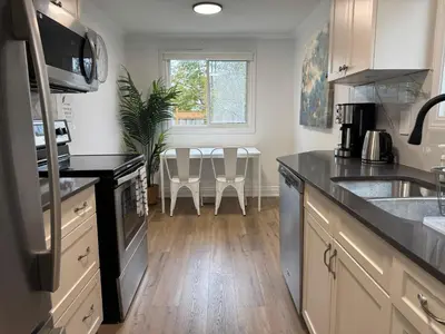 a kitchen with a sink and a counter top at North Barrie !D Stylish and Cozy Private Bedroom with Shared Bathroom in Barrie