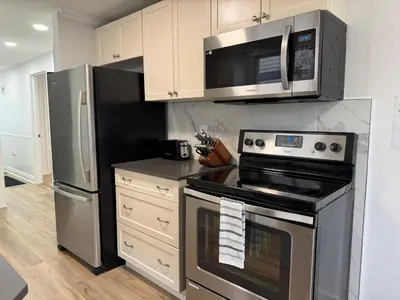 a kitchen with a stove and a refrigerator at North Barrie !D Stylish and Cozy Private Bedroom with Shared Bathroom in Barrie