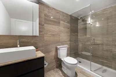 a bathroom with a toilet and a sink and a shower at Modern 4BR Home Sleeps 12 Steps to CN Tower in Toronto