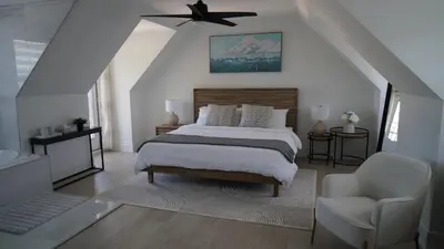 a bedroom with a bed and a ceiling fan at Water View - Modern Cottage in Niagara-on-the-Lake in Niagara on the Lake