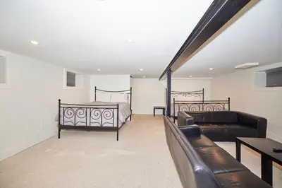 a living room with two beds and a couch at RIVERSIDE WALK in Niagara Falls