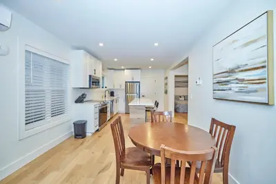 a kitchen and dining room with a wooden table and chairs at RIVERSIDE WALK in Niagara Falls