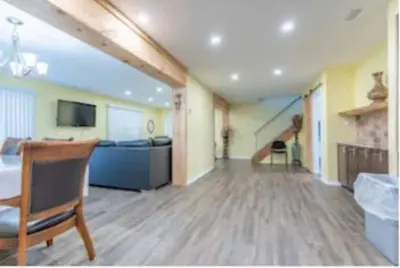 a large room with a bed and a couch and a television at Riverview Cottage Escape in Frankford