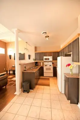 a kitchen with a white refrigerator and a table at SUPERIOR 2 in Niagara Falls