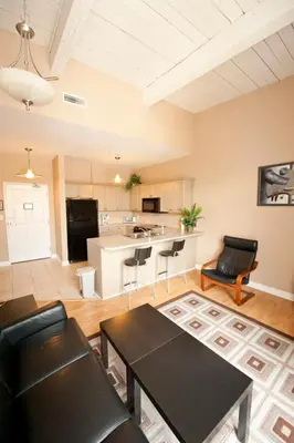 a living room with a table and chairs and a kitchen at SUPERIOR 3 in Niagara Falls