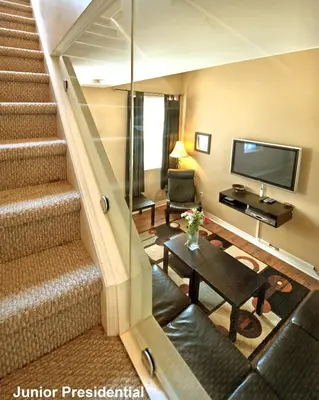 a living room with a staircase and a television at Superior 5 in Niagara Falls