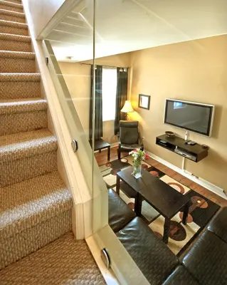 a living room with a staircase and a television at Superior 5 in Niagara Falls