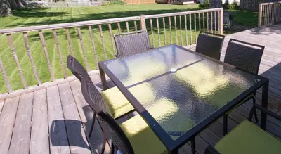 a glass table and chairs on a deck at WALK TO THE BEACH in Fort Erie