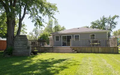 a house with a fence and a yard at WALK TO THE BEACH in Fort Erie