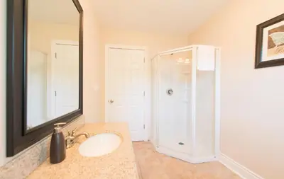 a bathroom with a sink and a shower with a mirror at WALK TO THE BEACH in Fort Erie