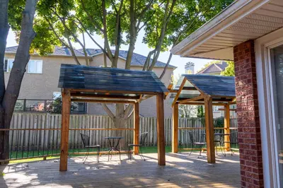 a patio with two blue picnic tables and chairs at Elegant Mansion with Private Bar & Game Lounge in Mississauga