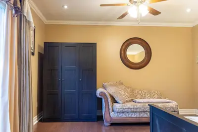 a living room with a couch and a mirror at Elegant Mansion with Private Bar & Game Lounge in Mississauga