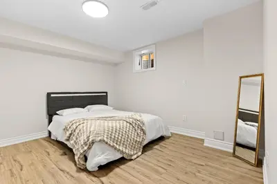 a white bedroom with a bed and a mirror at 6BR Luxe Family Home,Safari Area, Entertainment in Milton