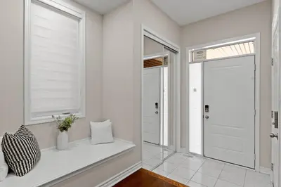 a white hallway with a window seat and a door at 6BR Luxe Family Home,Safari Area, Entertainment in Milton