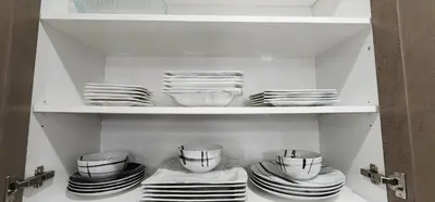 a cupboard filled with plates and bowls and dishes at 6BR Luxe Family Home,Safari Area, Entertainment in Milton
