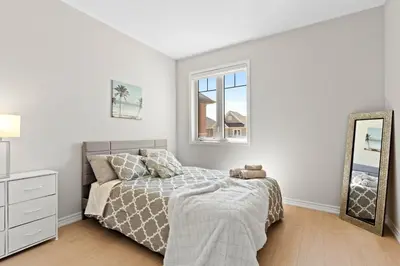 a white bedroom with a bed and a mirror at 6BR Luxe Family Home,Safari Area, Entertainment in Milton