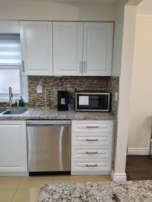a kitchen with white cabinets and a microwave at Newly Renovated 3BR Upper Unit - Bright & Quiet in Richmond Hill