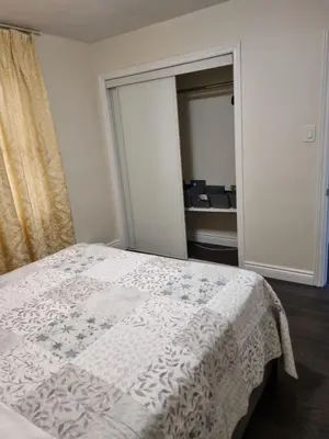 a bedroom with a bed with a white blanket at Newly Renovated 3BR Upper Unit - Bright & Quiet in Richmond Hill
