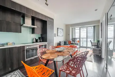a kitchen and dining room with a table and chairs at Bright High Floor1 Bedroom Condo Downtown Toronto in Toronto
