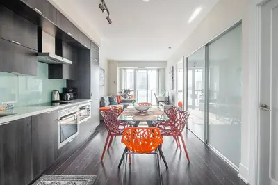 a kitchen with a table and chairs in a room at Bright High Floor1 Bedroom Condo Downtown Toronto in Toronto