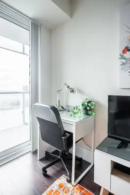 an office with a desk and a chair and a television at Bright High Floor1 Bedroom Condo Downtown Toronto in Toronto