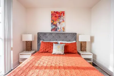 a bedroom with a large bed with two lamps at Bright High Floor1 Bedroom Condo Downtown Toronto in Toronto