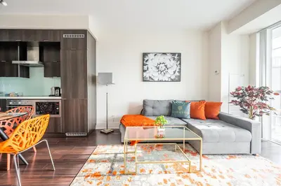 a living room with a couch and a table at Bright High Floor1 Bedroom Condo Downtown Toronto in Toronto