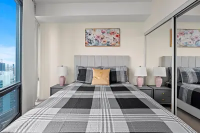 a bedroom with a large bed with two lamps at High Floor 1 Bedroom Condo City View Downtown Toronto in Toronto
