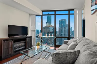 a living room with a couch and a large window at High Floor 1 Bedroom Condo City View Downtown Toronto in Toronto