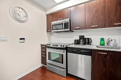 a kitchen with stainless steel appliances and a microwave at High Floor 1 Bedroom Condo City View Downtown Toronto in Toronto