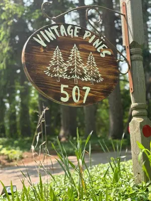 a sign for a winter park with pine trees on it at Vintage Pines Guest House in Niagara on the Lake