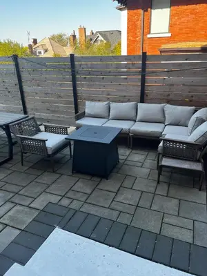 a patio with a couch and chairs and a table at 1Br Apt In Mansion With Indoor Pool Hot Tub in Hamilton