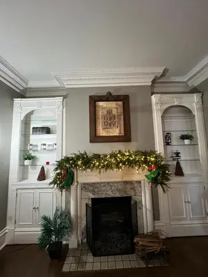 a living room with a fireplace with christmas decorations at 1Br Apt In Mansion With Indoor Pool Hot Tub in Hamilton