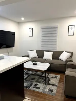a living room with a couch and a table at Cozy 2-Bed with Kitchen and Patio in Midtown Toronto in Toronto