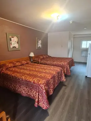 a hotel room with two beds and a window at Skyways Motel in Gravenhurst