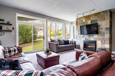 a living room with a couch and a fireplace at Easy Rider Chalet Steps to Lift & Blue Village in Blue Mountains