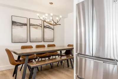 a dining room with a table and a refrigerator at Lift Side Luxury Newly renovated walk to village in Blue Mountains